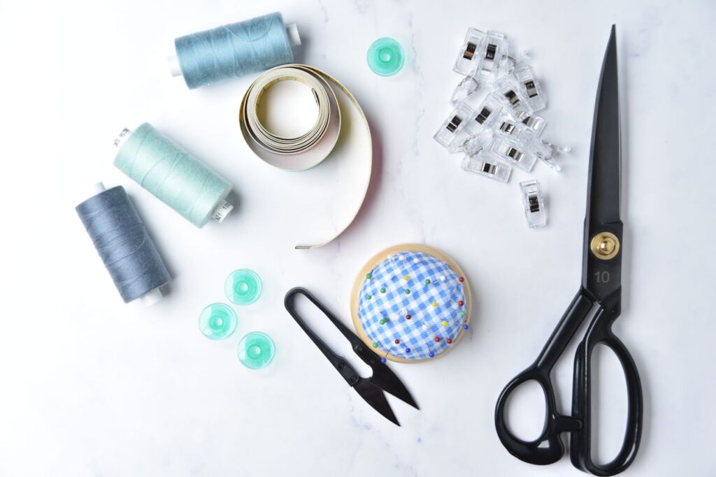 A collection of sewing essentials arranged on a white surface for craft enthusiasts.